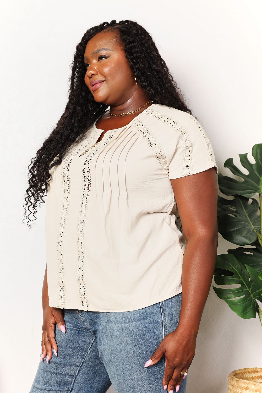 Light yellow Trendsi Double Take crochet short sleeve top with button accents, featuring a relaxed fit and textured knit fabric.