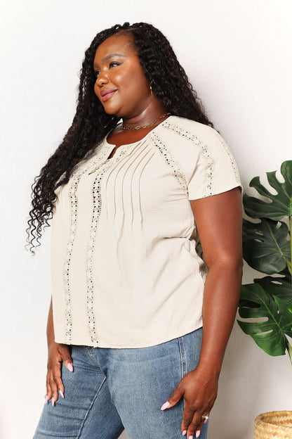 Light yellow Trendsi Double Take crochet short sleeve top with button accents, featuring a relaxed fit and textured knit fabric.