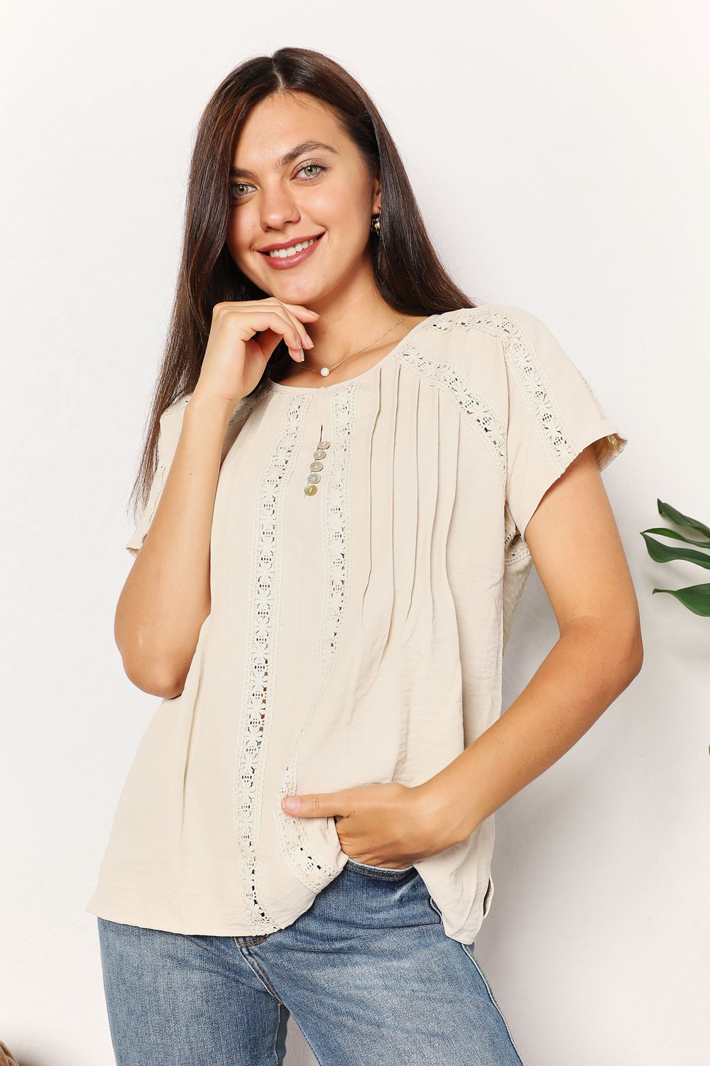 Light yellow crochet short sleeve top with button details, from Trendsi's Double Take collection, displayed on a mannequin.