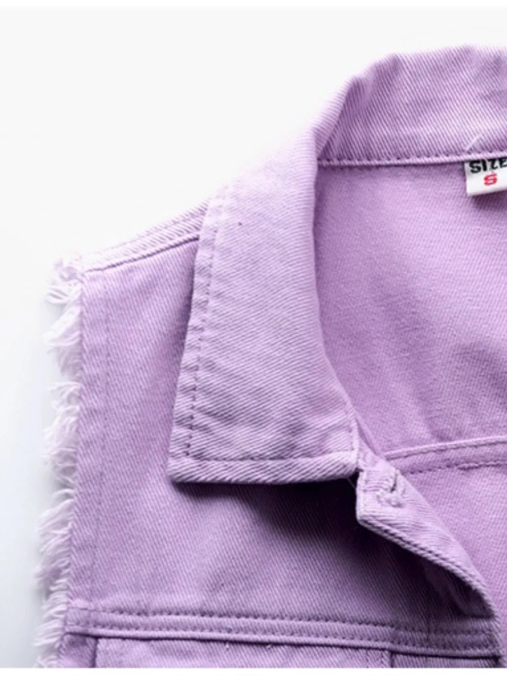 Plus size lilac sleeveless denim jacket with full button-down front and raw hem, by Trendsi, shown on a model.