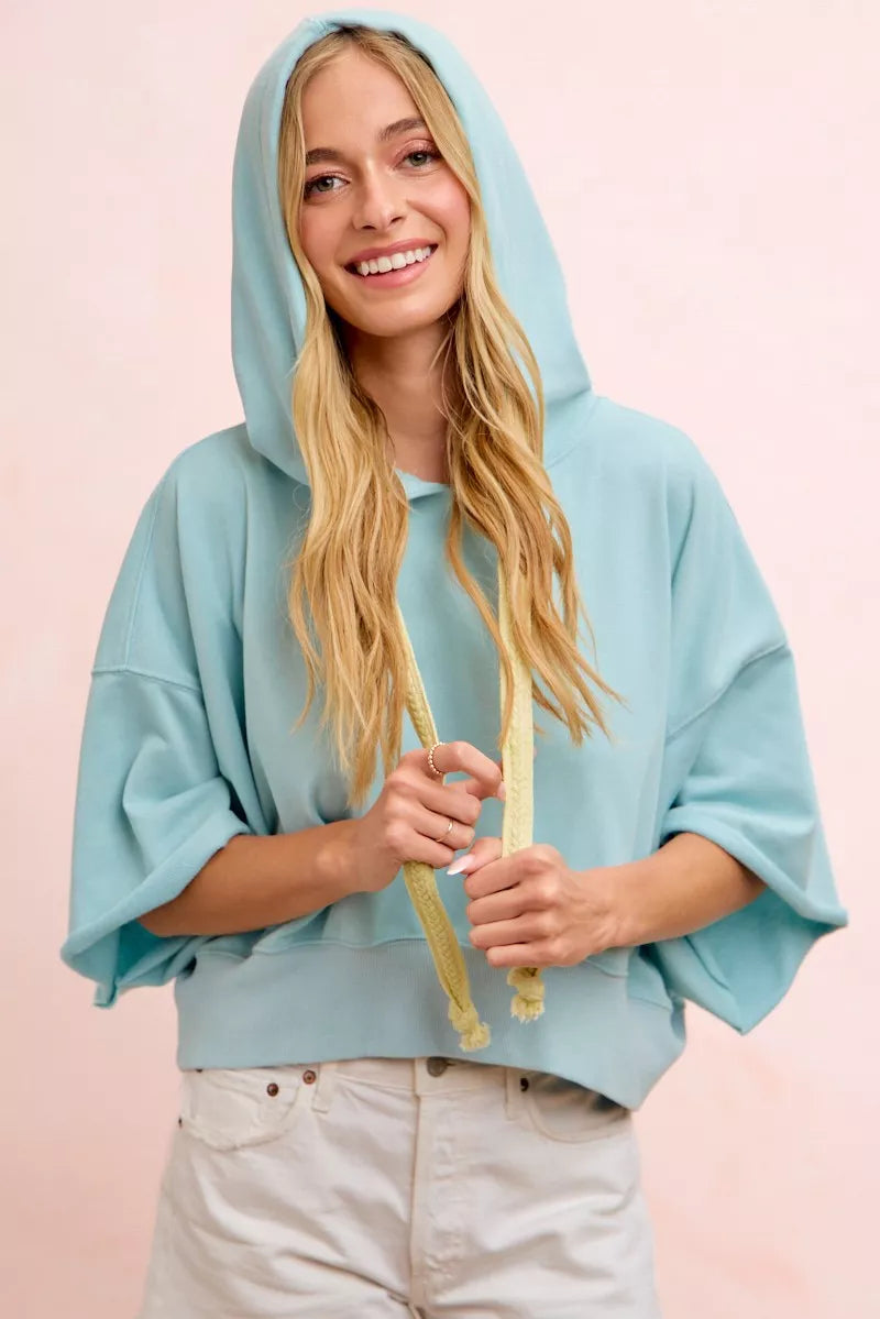 Light blue BiBi washed terry short sleeve drawstring hoodie top from Trendsi, casual and comfortable for everyday wear.