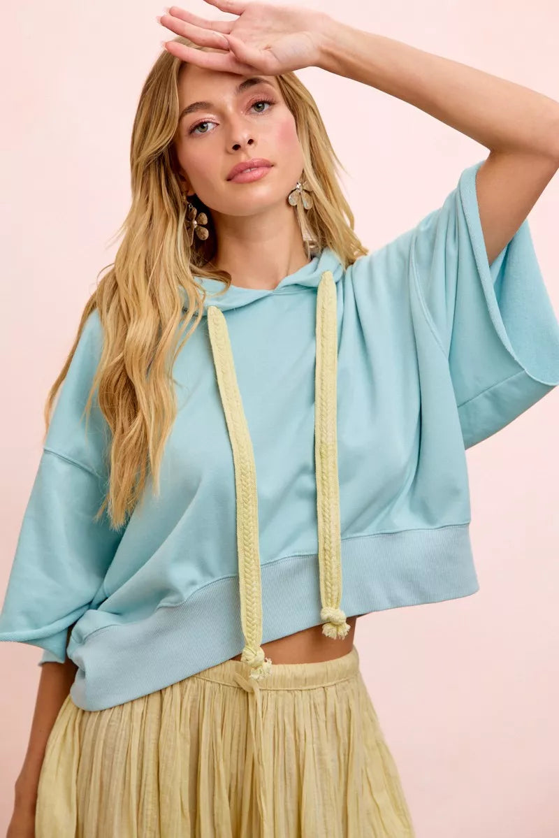 Light blue BiBi washed terry short sleeve hoodie top with drawstring neckline, casual and comfortable for everyday wear.