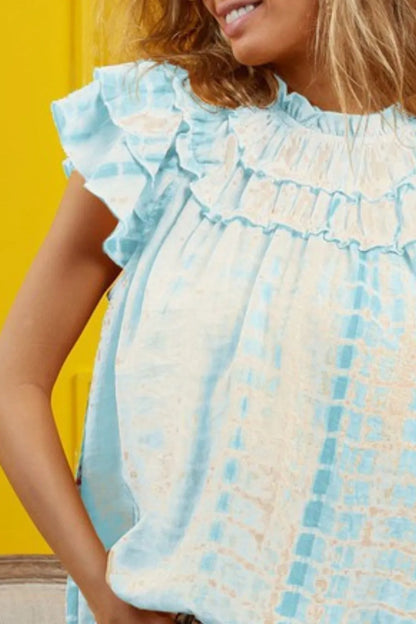 Blue tie-dye tiered ruffle neck top by Trendsi, featuring a chic, flowy design with ruffled accents and a stylish tie neckline.