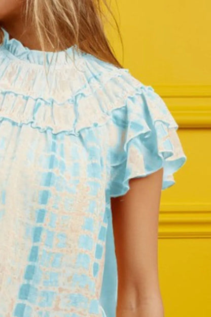 Blue tie-dye tiered ruffle neck top by Trendsi, featuring a stylish, flowy design with ruffle details and a tie-front neckline.