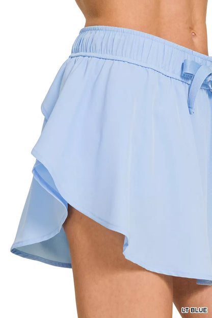 Light blue Zenana soft woven active skorts with pockets, featuring a comfortable fit and sporty design for active wear.