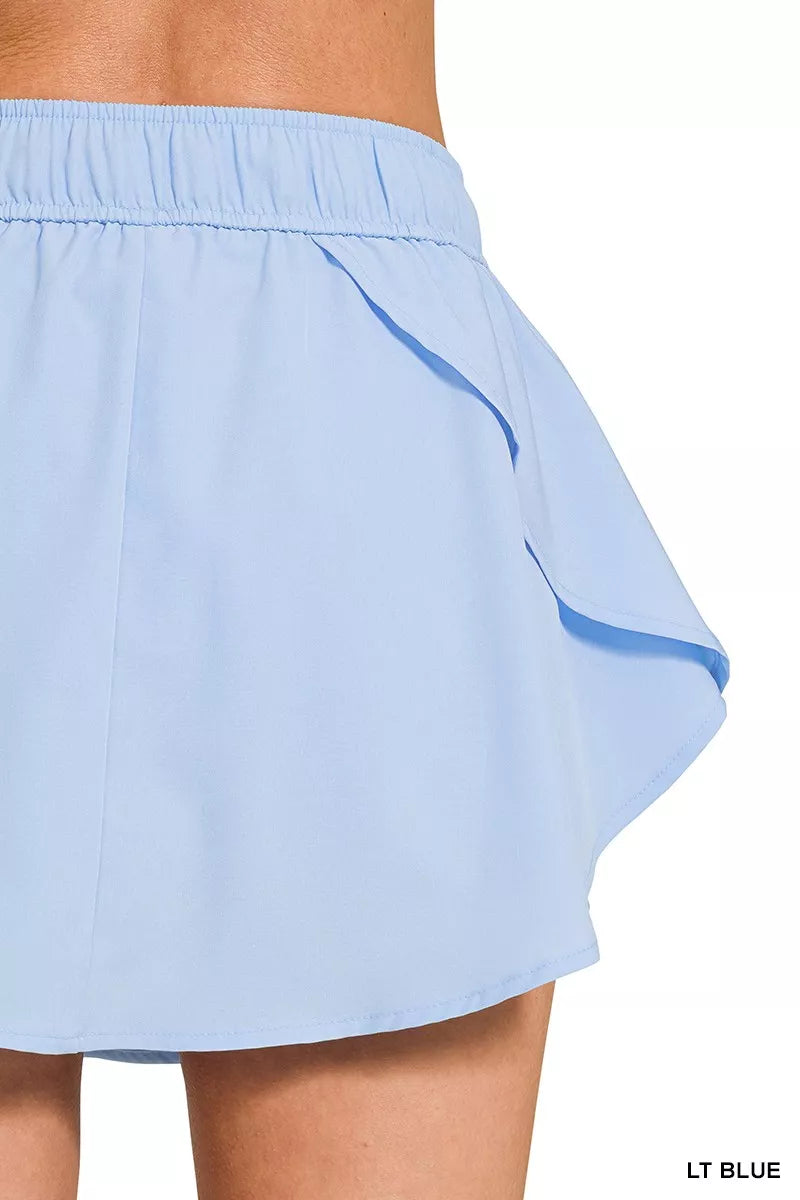 Light blue Zenana woven active skorts with pockets, featuring a soft fabric and comfortable fit for active wear.