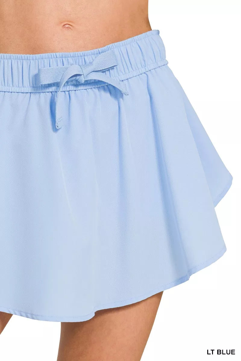 Light blue Zenana soft woven active skorts with pockets, featuring a comfortable fit and athletic design for active wear.