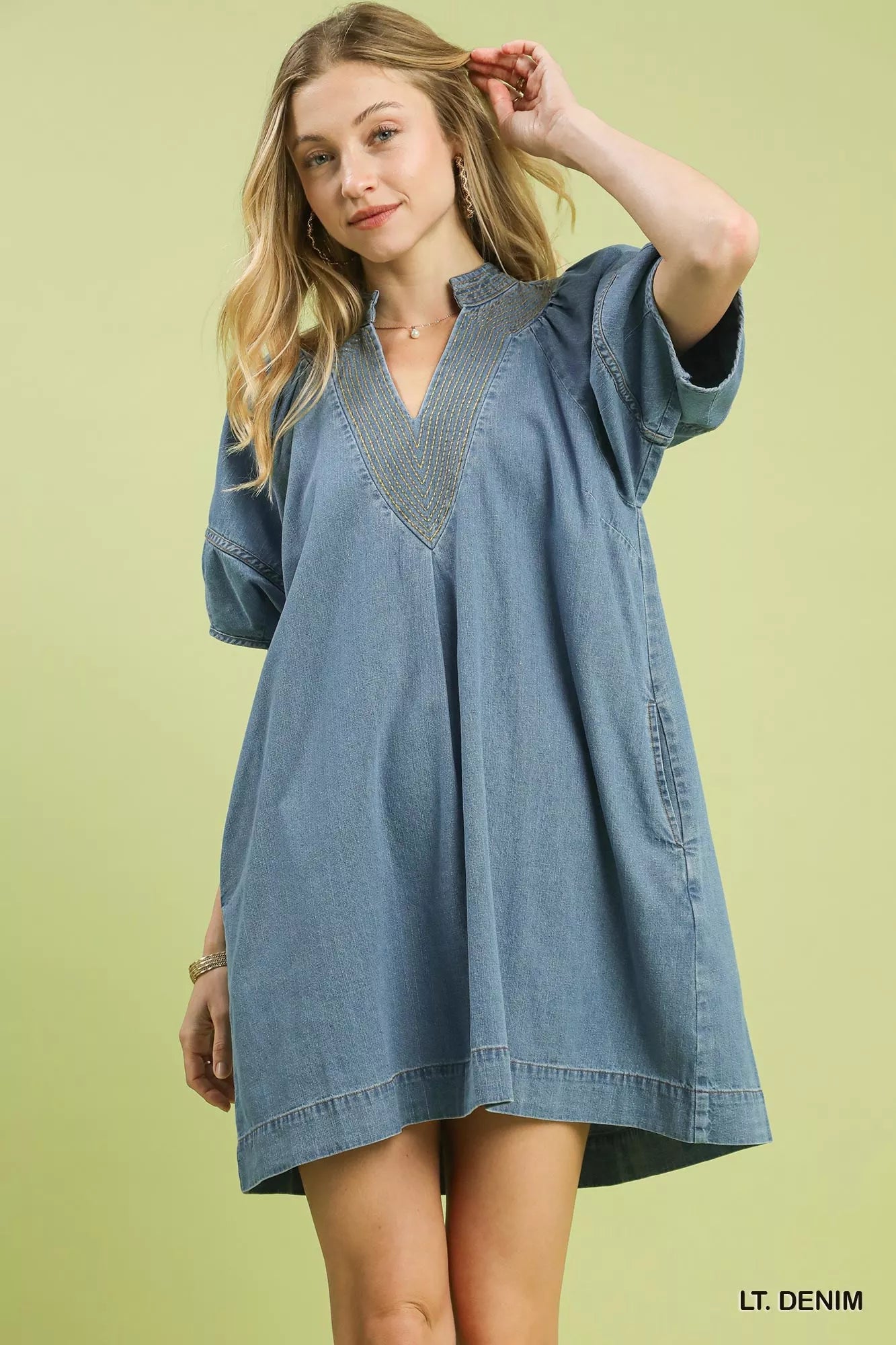 Light blue Umgee denim mini dress with contrast thread detailing, short sleeves, and a casual, stylish fit.