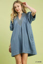 Light blue Umgee denim mini dress with contrast thread detailing, short sleeves, and a casual, stylish fit.