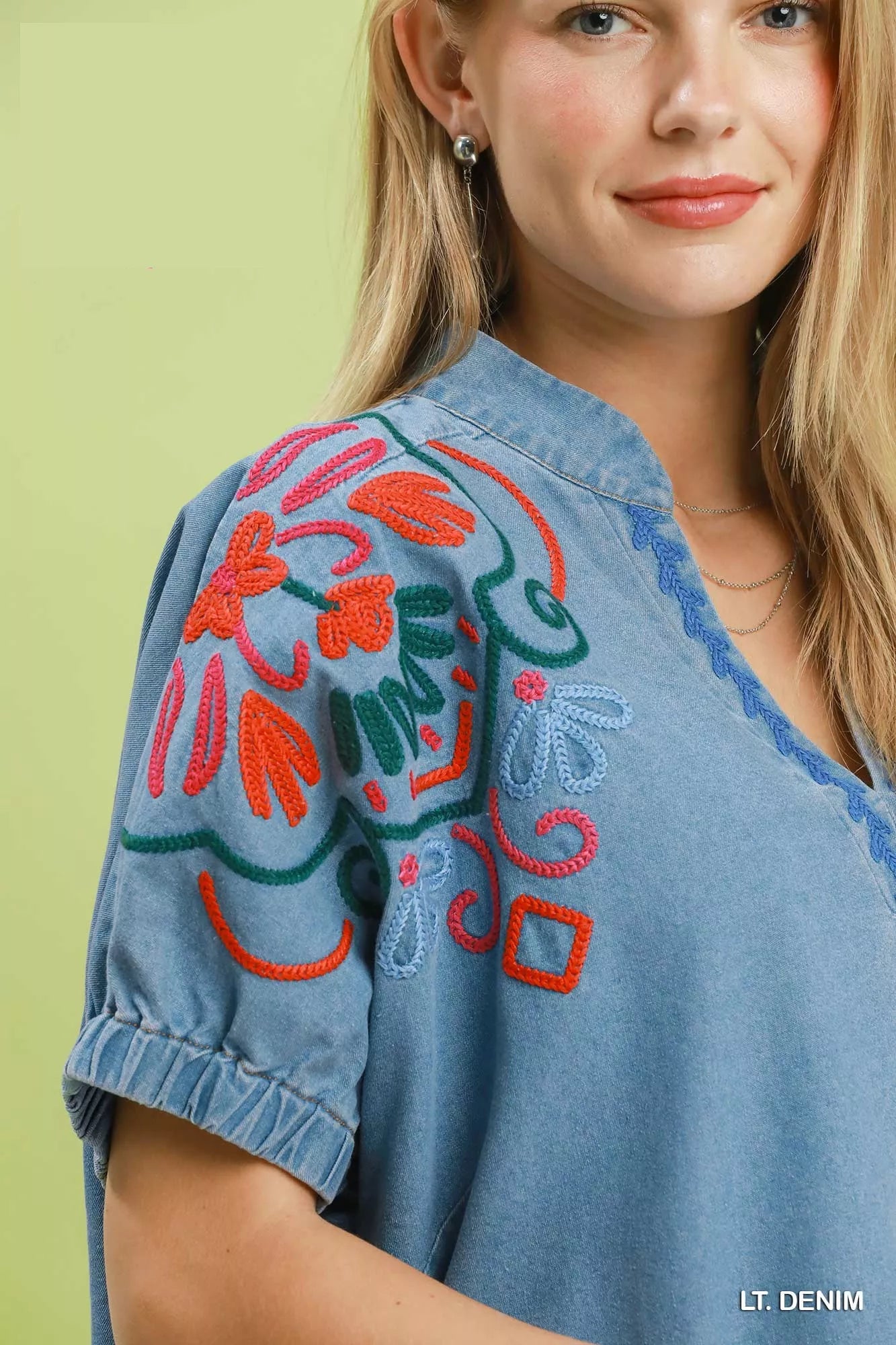 Light blue embroidered denim puff sleeve top from Umgee, featuring intricate embroidery and stylish puffed sleeves.