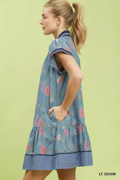 Umgee floral contrast trim ruffle hem mini dress featuring a feminine design and vibrant floral pattern.