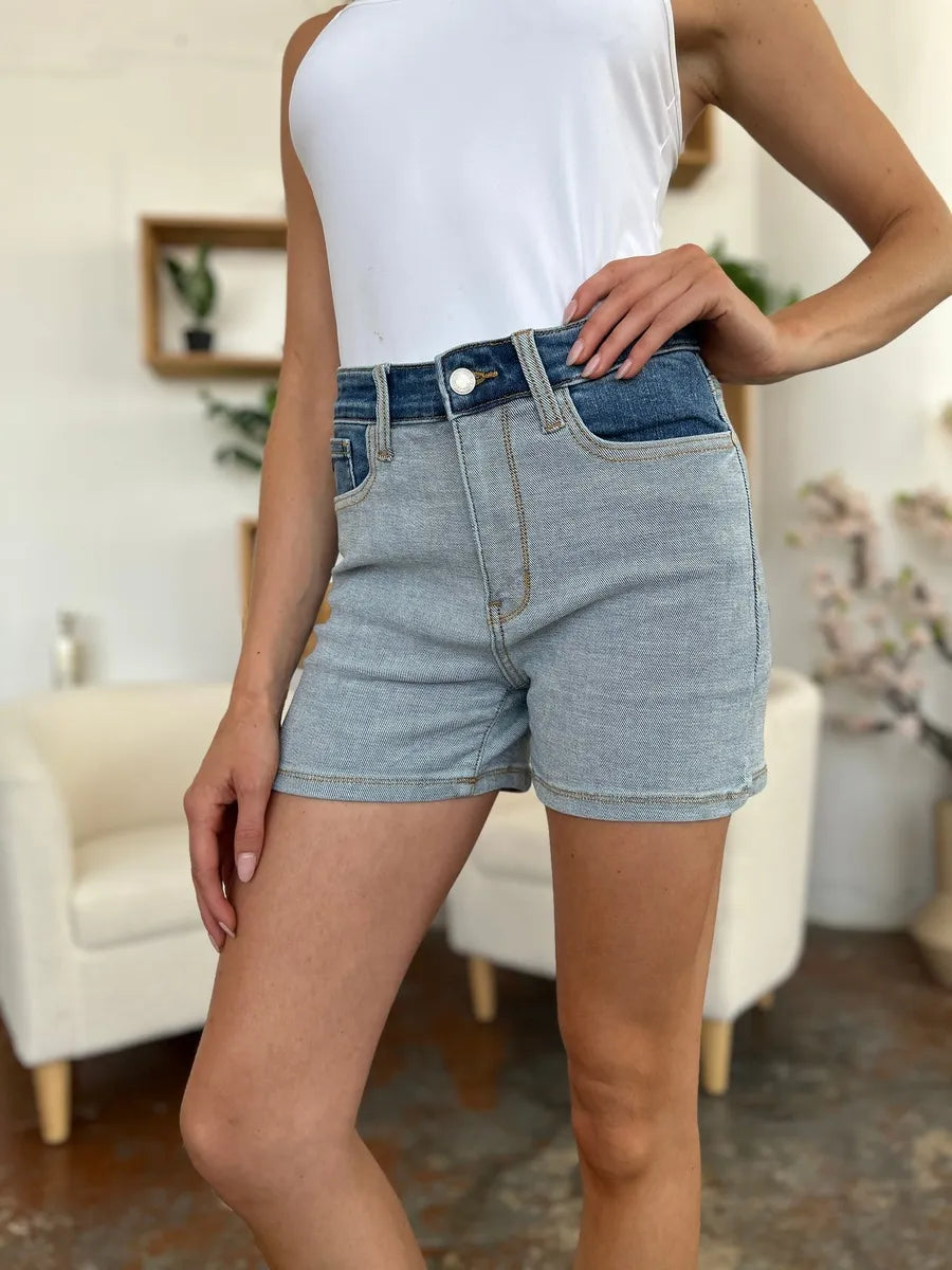 Color block denim shorts by Judy Blue featuring a full size fit, styled with contrasting fabric panels for a trendy casual look.