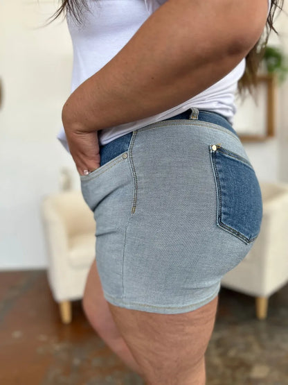 Full size Judy Blue color block denim shorts with a high waist and rolled hems, styled with front and back pockets.