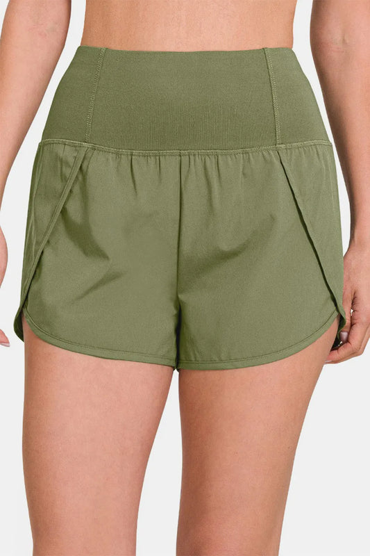 Olive green Zenana high-waisted active shorts with zippered back pocket, designed for comfortable workout and athletic wear.