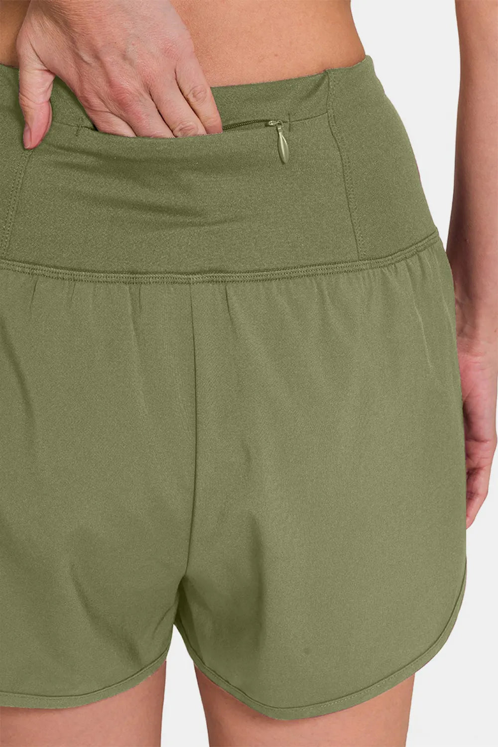 Olive green Zenana high-waisted active shorts with zippered back pocket and comfortable fit, perfect for workout or casual wear.