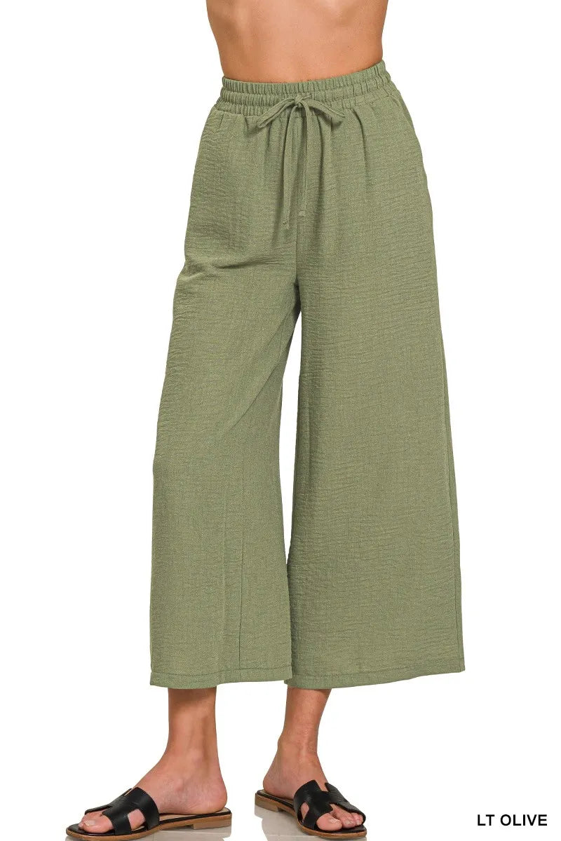 Olive green Zenana woven crepe cropped pants with elastic waistband, featuring a relaxed fit and stylish design.