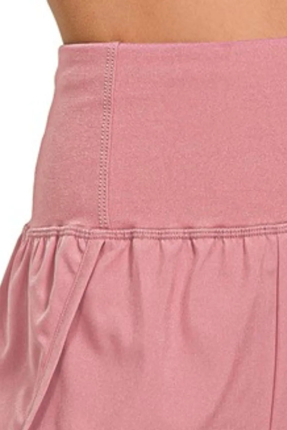 Zenana high waisted running shorts with zippered back pocket in soft rose color, designed for active women.