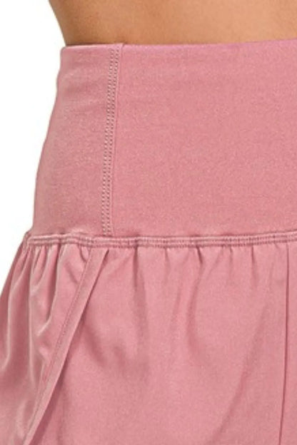 Zenana high waisted running shorts with zippered back pocket in soft rose color, designed for active women.