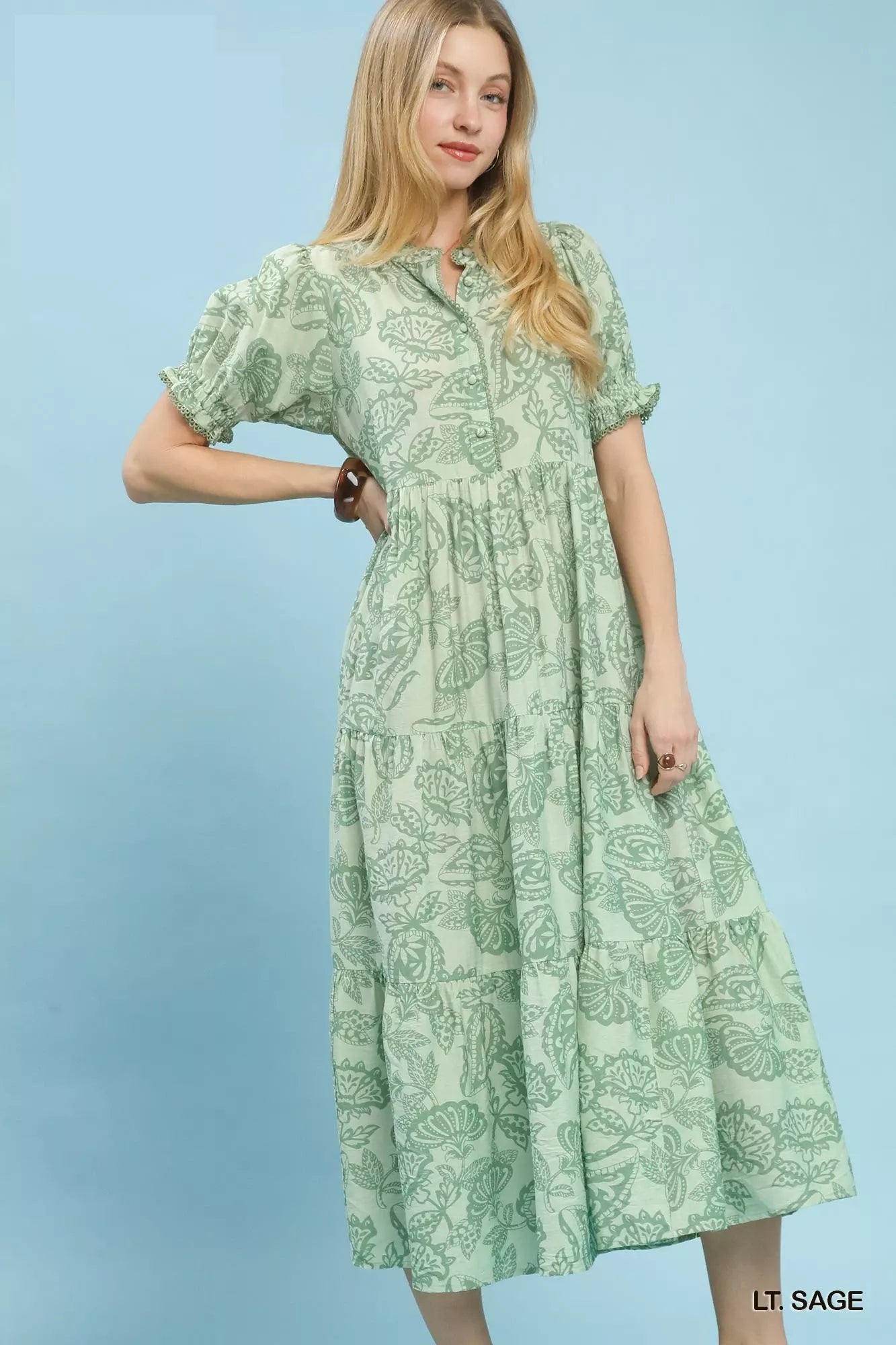 Umgee paisley print tiered midi dress in sage green, showcasing its flowing fabric and intricate paisley pattern.