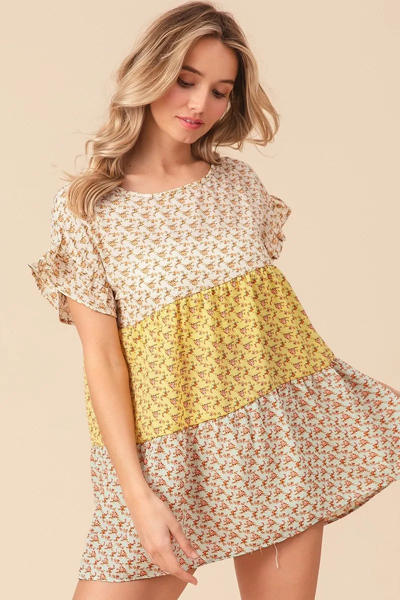 Yellow and sage floral printed woven tiered top by Trendsi featuring color block design and sleeveless style.
