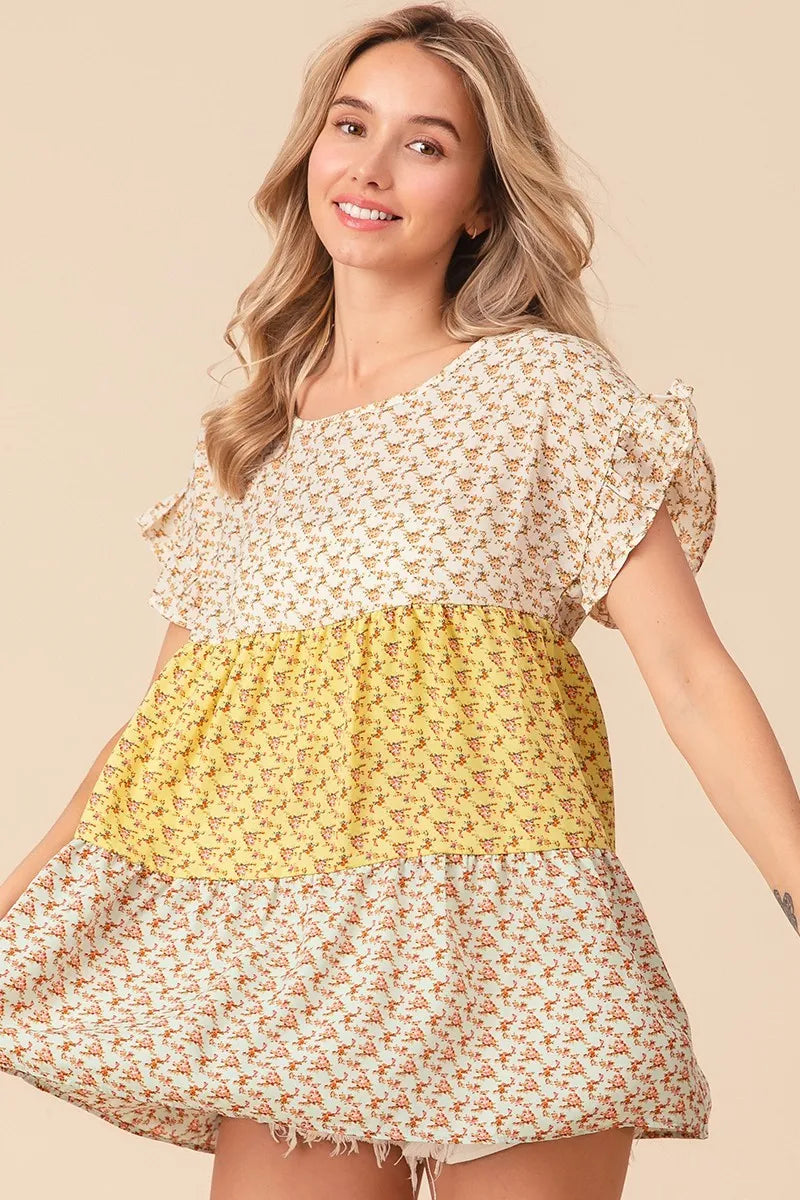 Trendsi BiBi floral printed woven color block and tiered top in yellow and sage, featuring a vibrant, flowy design.