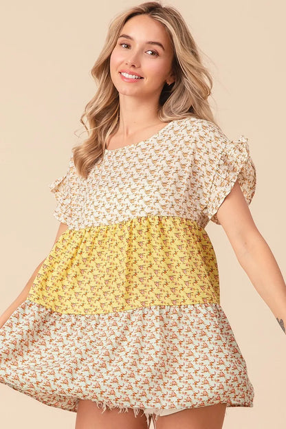 Trendsi BiBi floral printed woven color block and tiered top in yellow and sage, featuring a vibrant, flowy design.