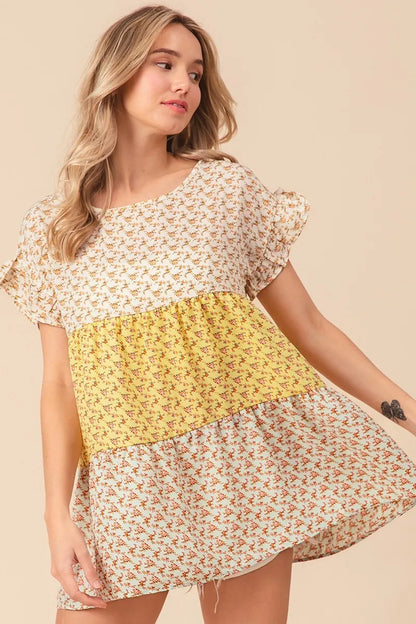 Trendi floral printed woven color block and tiered top in yellow and sage, featuring a stylish, flowy design.