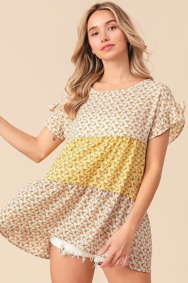 Trendi yellow and sage floral printed woven tiered top with color block design, perfect for casual wear.
