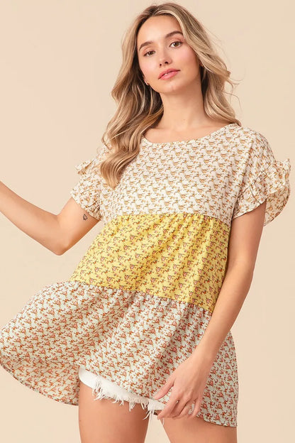 Trendi yellow and sage floral printed woven tiered top with color block design, perfect for casual wear.