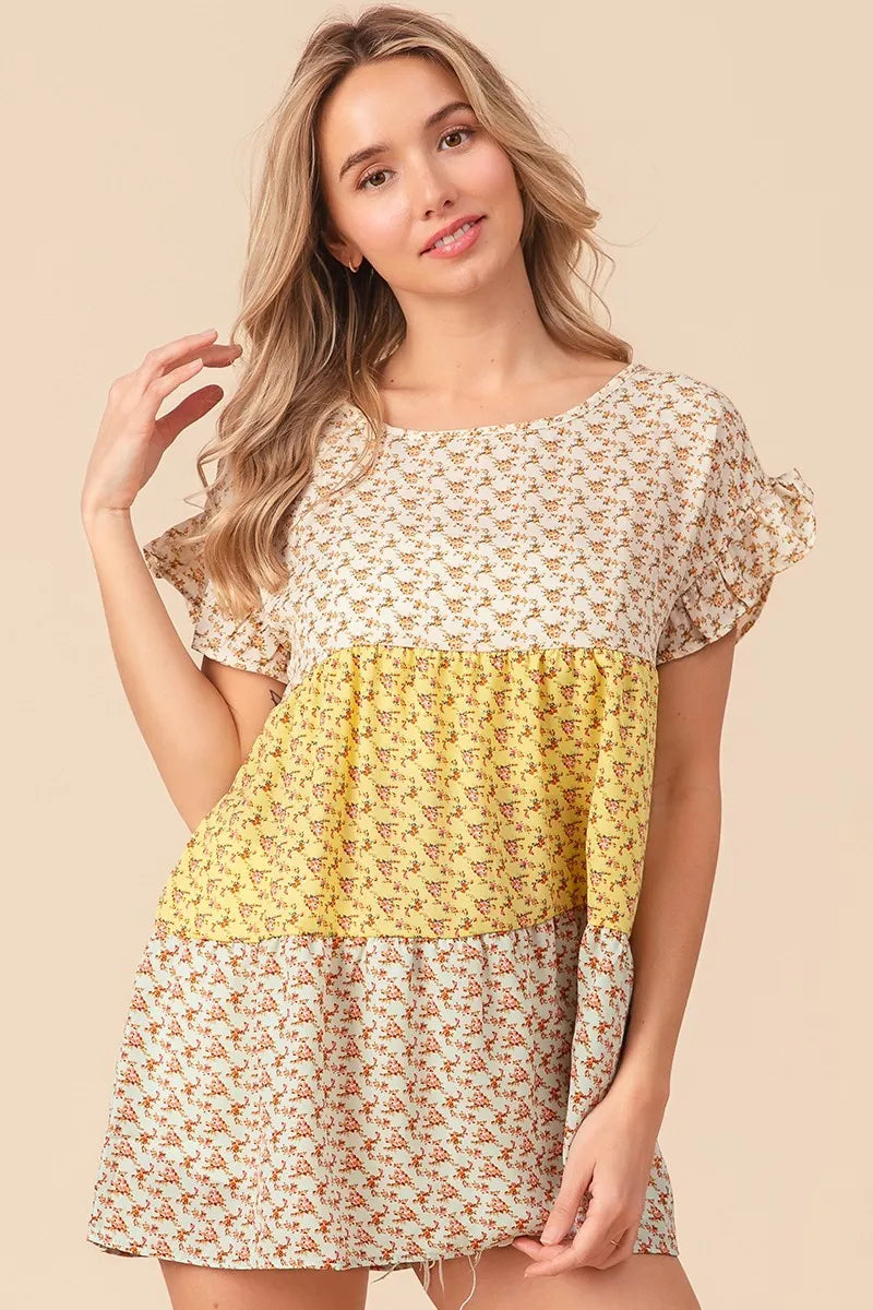 Trendsi BiBi floral printed woven color block and tiered top in yellow and sage, featuring a flowy, layered design.