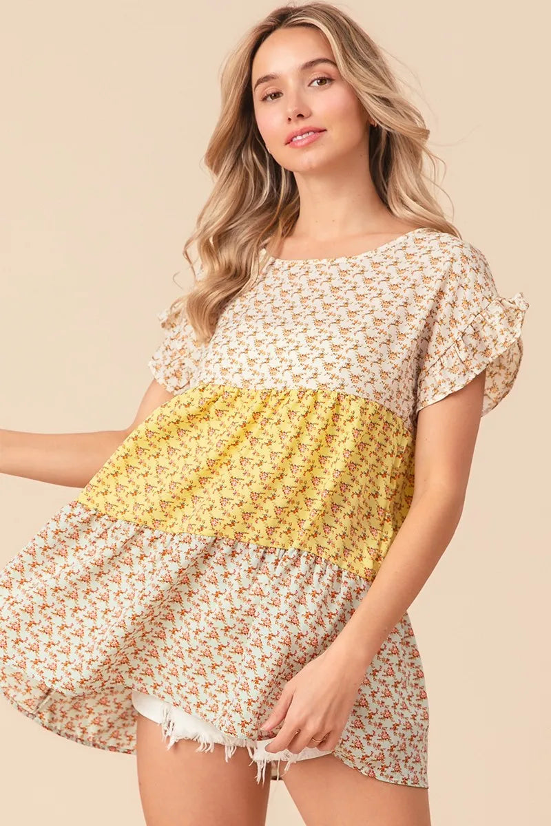 Trendsi BiBi floral printed woven tiered top with color block design in yellow and sage, featuring a flowy, layered silhouette.
