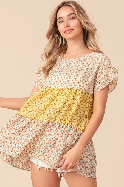 Trendsi BiBi floral printed woven tiered top with color block design in yellow and sage, featuring a flowy, layered silhouette.
