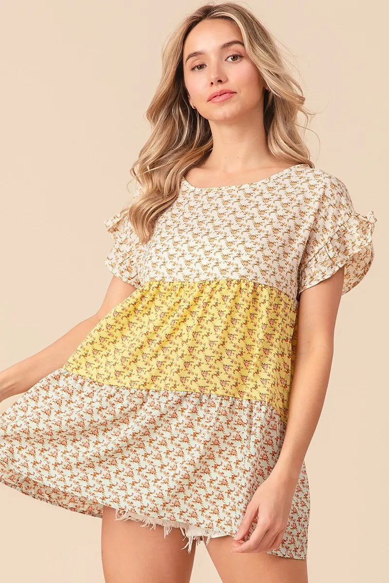 Trendsi BiBi floral printed woven color block and tiered top in yellow and sage, featuring a flowy, layered design.