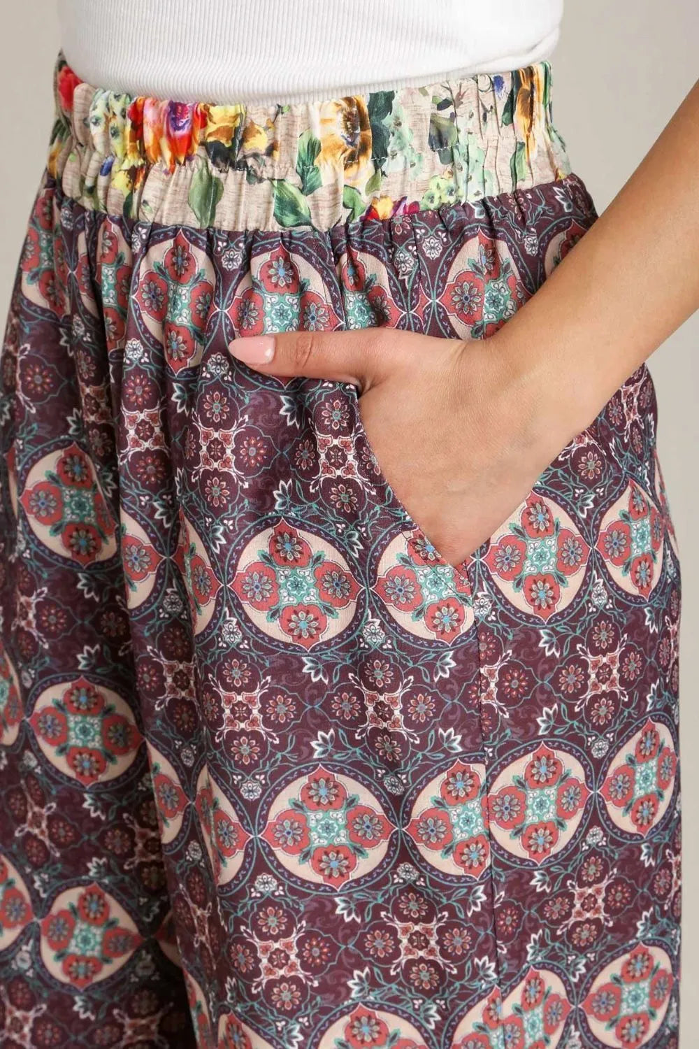 Plus size Umgee mixed print elastic waistband pants with maroon and neutral tones, designed for a comfortable fit.
