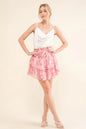 Mauve-red tiered skort with printed lurex fabric, smocked waist, and feminine design from Trendsi's And The Why collection.