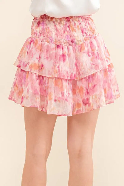 Mauve-red tiered skort with lurex print, smocked waist, and ruffle details, styled as a fashionable women's casual skirt.