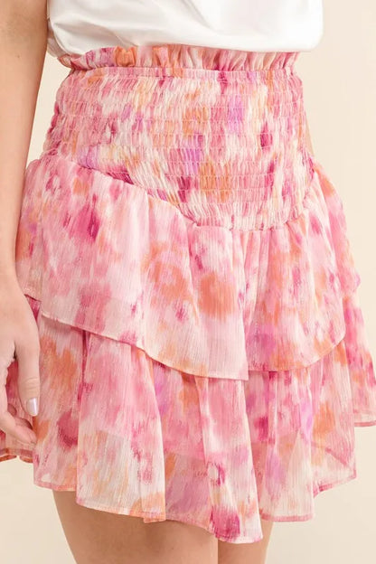 Mauve red printed lurex smocked waist tiered skort by Trendsi, featuring a flowy, layered design and shiny fabric details.
