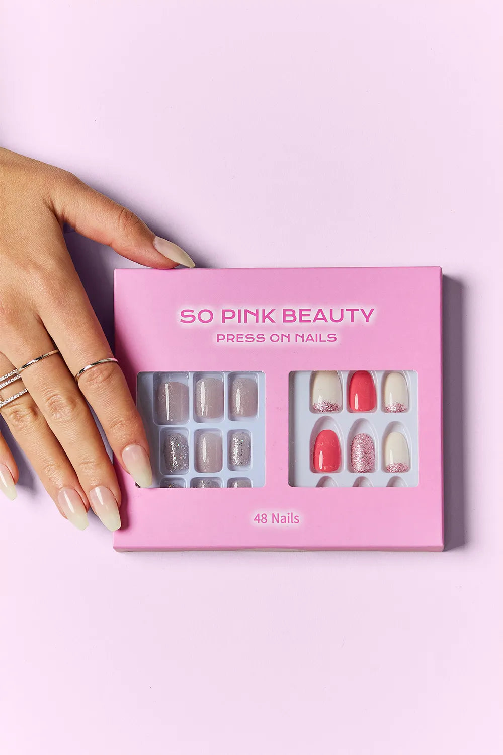 Trendsi SO PINK BEAUTY press-on nails in two packs, featuring natural pink nail designs on a clear display.