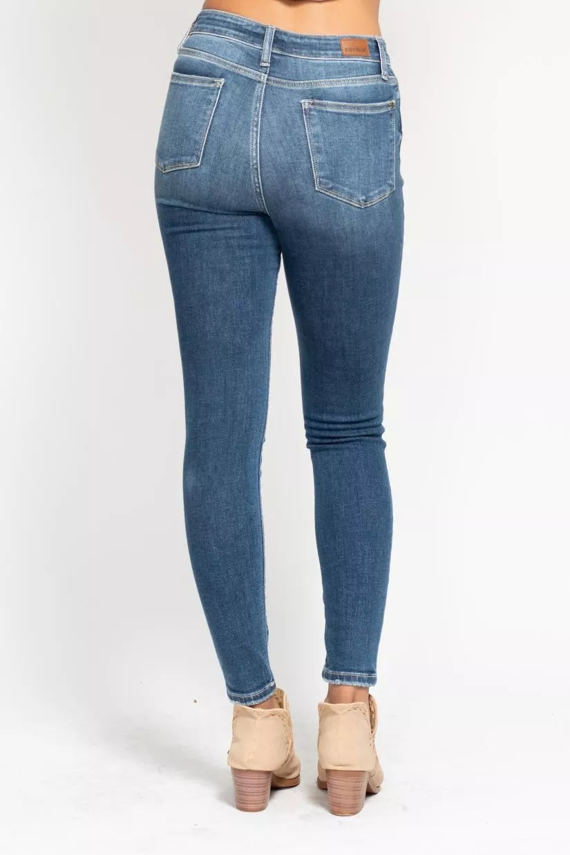Plus size Judy Blue high-rise skinny jeans with button fly, full size, trendy fit, shown in denim fabric.
