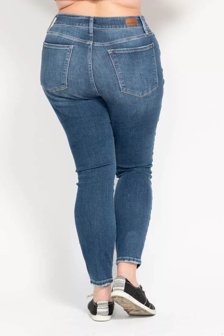 Plus size Judy Blue high-rise skinny jeans with button fly and full size fit, shown in a natural denim color.