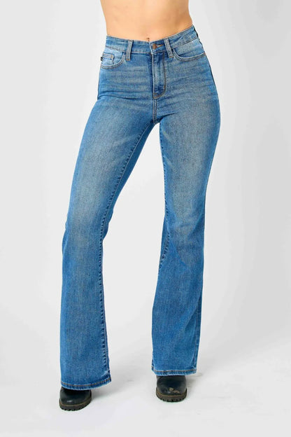 Plus size Judy Blue high-waisted classic flare jeans with a full-length fit and structured waistband, styled on a model.