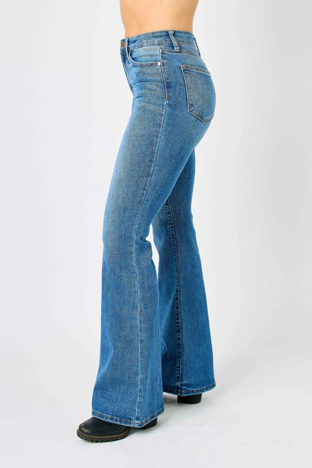 Plus size Judy Blue high-waisted flare jeans, full-length with classic style, shown on a model highlighting fit and denim texture.