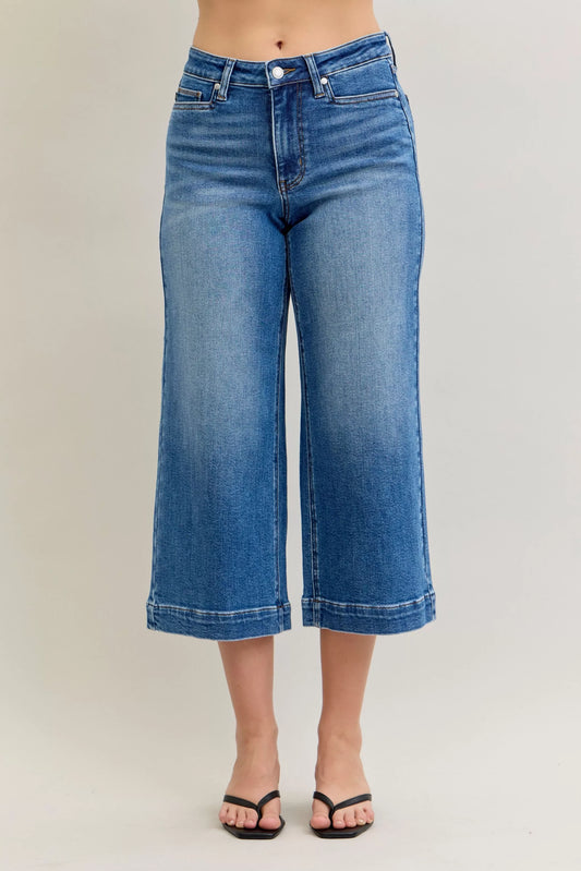 Mid-rise Judy Blue crop wide-leg jeans from Trendsi, showcasing fitted waist, relaxed wide legs, and classic denim style.