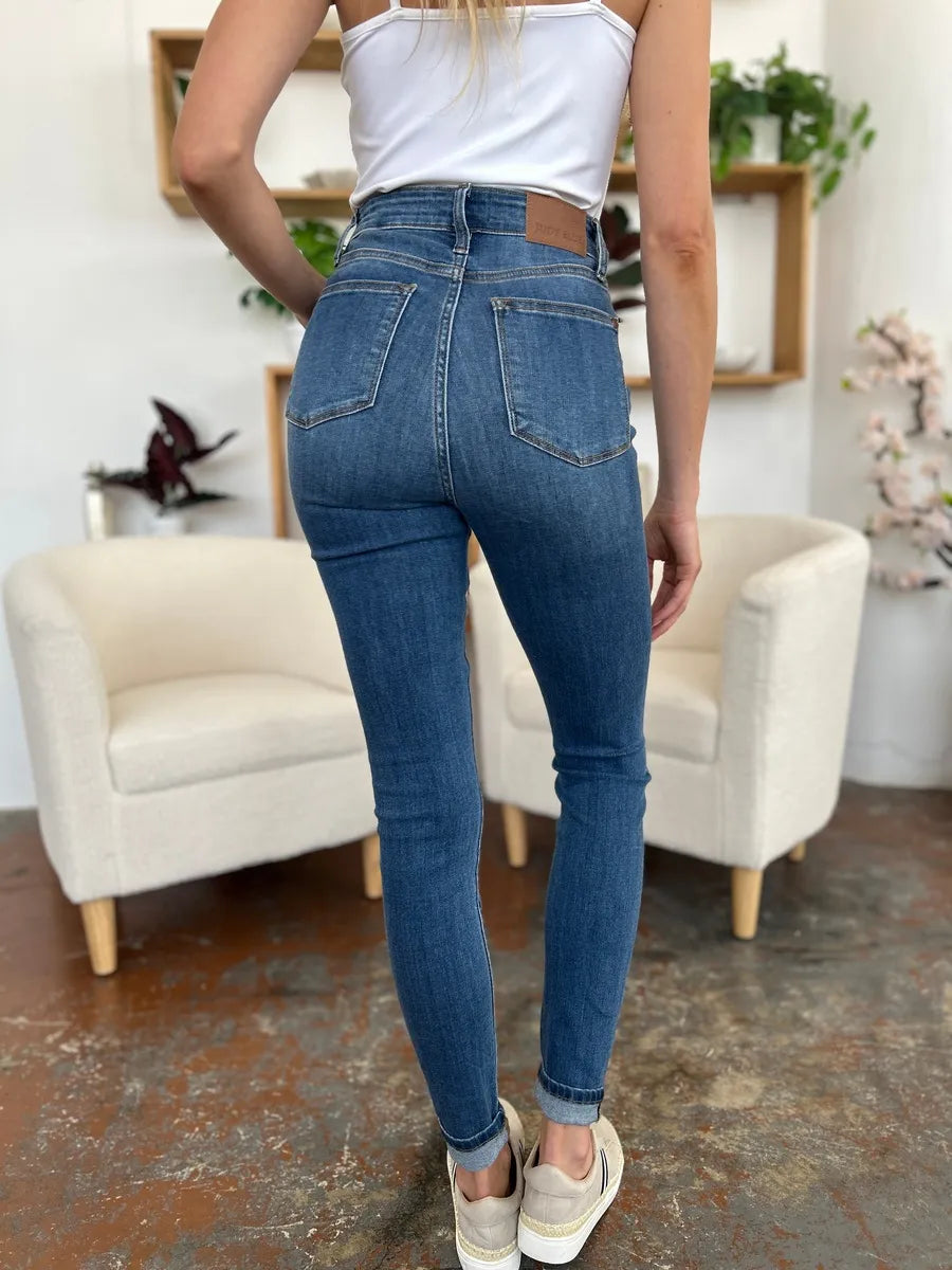 Full size Judy Blue cuffed hem skinny jeans by Trendsi, showing a close-up of the denim fabric and cuffed leg detail.