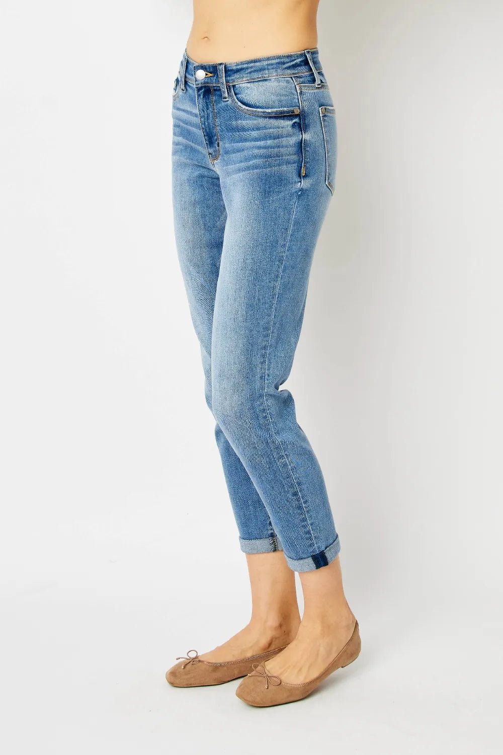 Full view of Judy Blue full-size cuffed hem slim jeans with classic five-pocket design and dark wash, hanging on a hanger.
