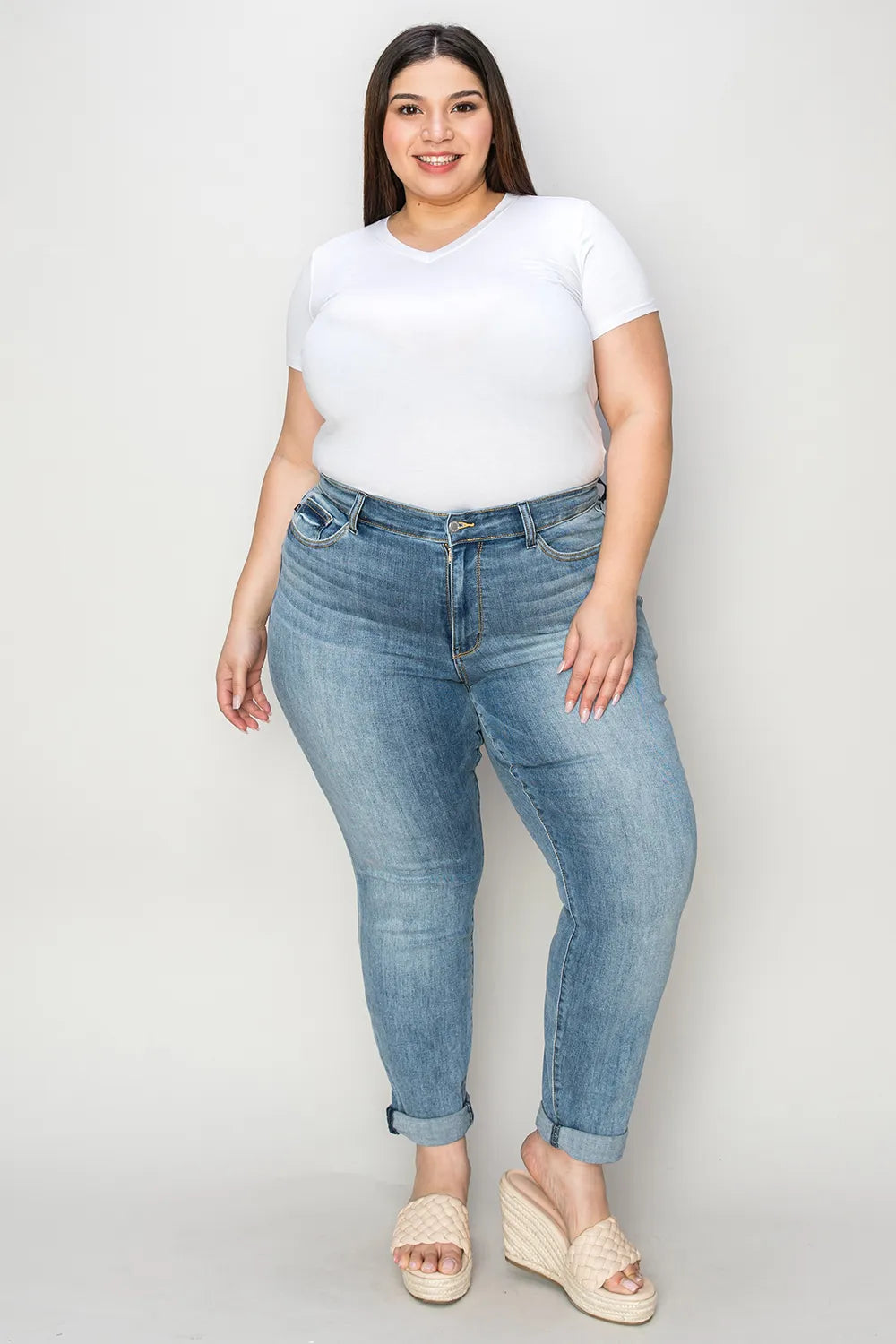 Full-size Judy Blue slim jeans with cuffed hem, featuring a fitted silhouette and classic denim wash.