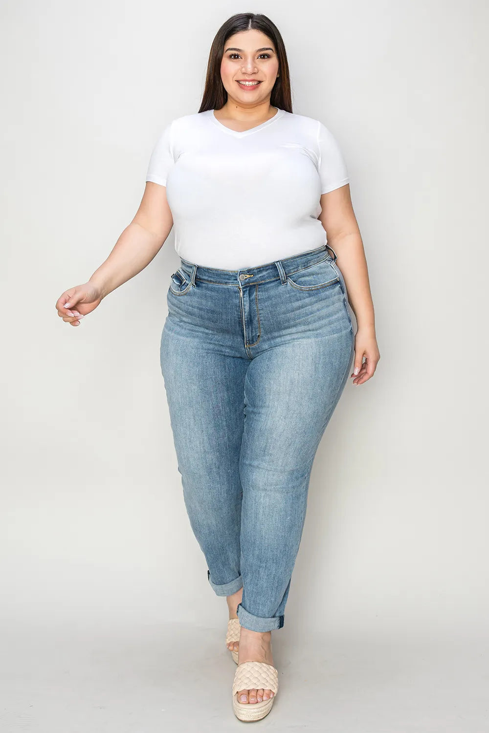 Judy Blue full-size cuffed hem slim jeans in blue denim, showing a close-up of the fitted design and cuffed ankle detail.