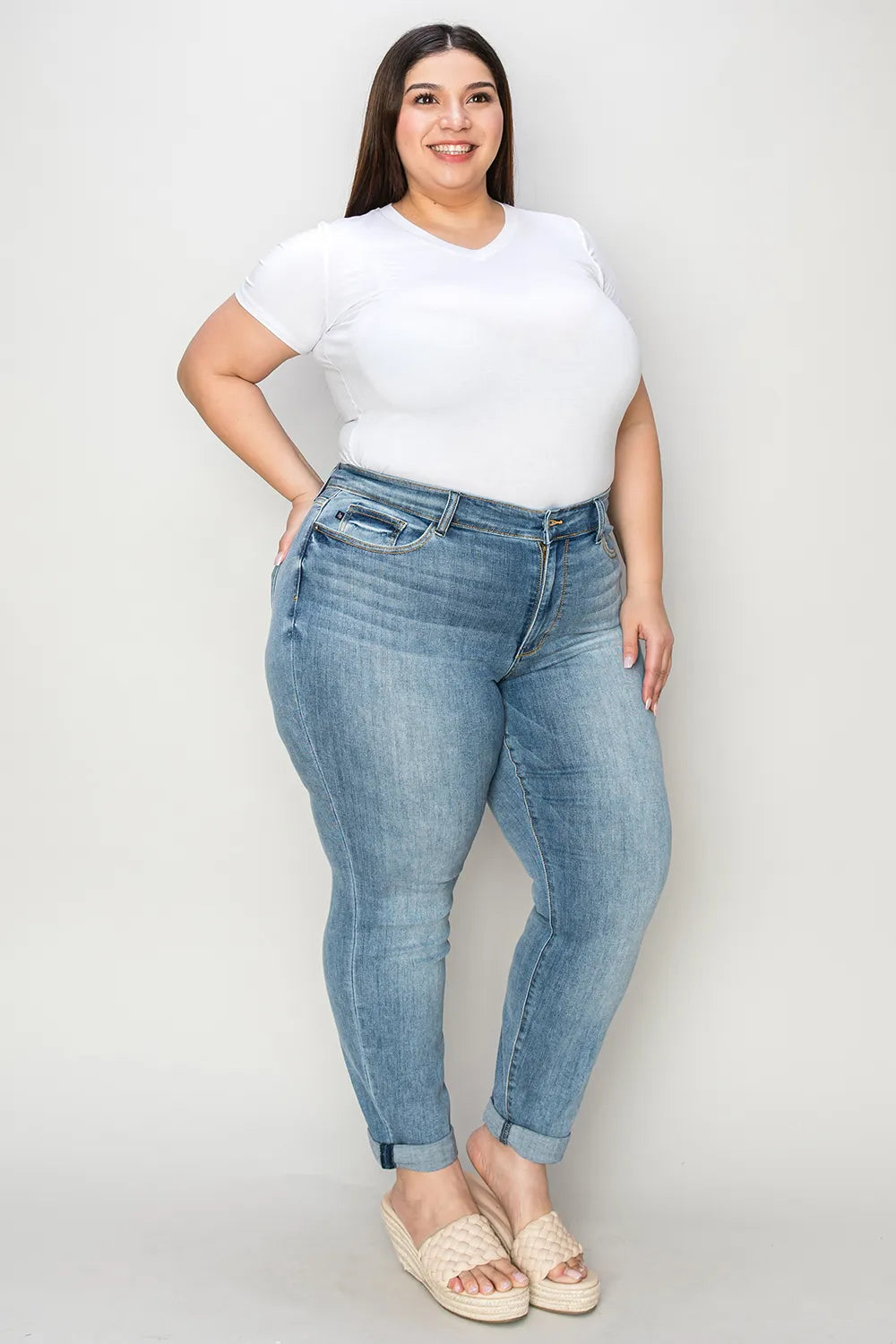 Medium shot of Judy Blue full size cuffed hem slim jeans showing the fit and cuffed detail on a model.