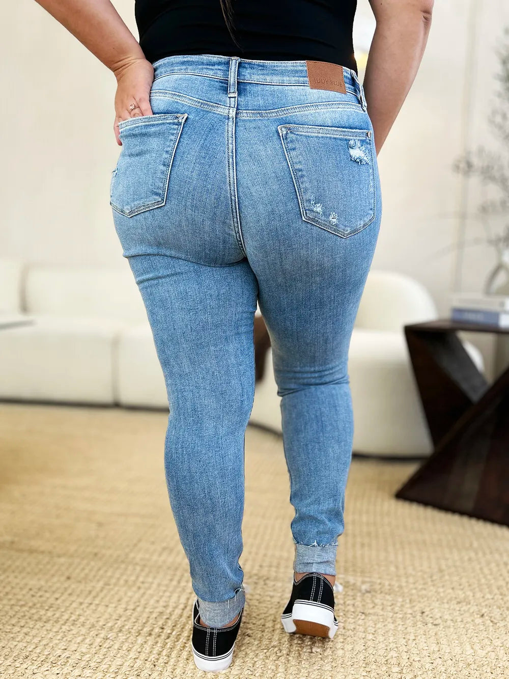 Judy Blue full-size mid-rise skinny jeans with distressed details and rolled cuffs, stylish denim from Trendsi.