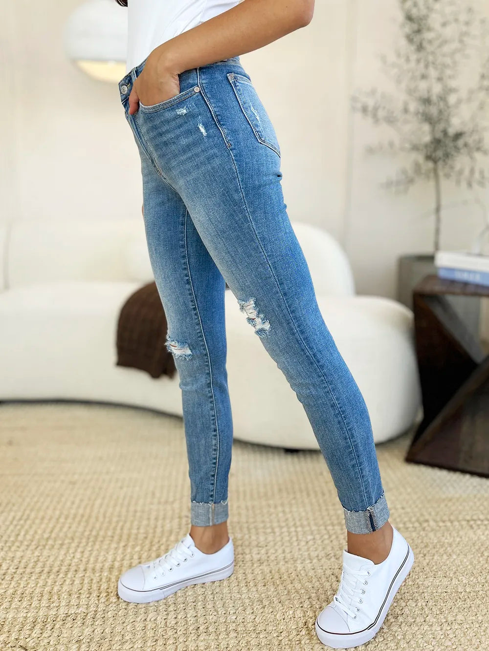 Judy Blue full-size mid-rise skinny jeans with distressed details and rolled cuffs, showcasing trendy denim style.